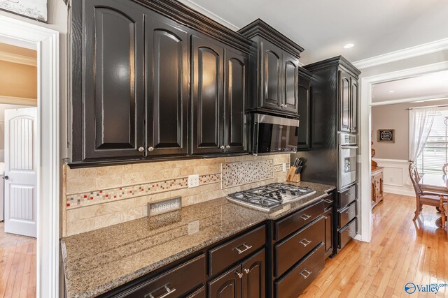 14690 Birchbark St, Athens, AL 35613 - kitchen with crown molding, stone countertops, appliances with stainless steel finishes, and light wood-style floors