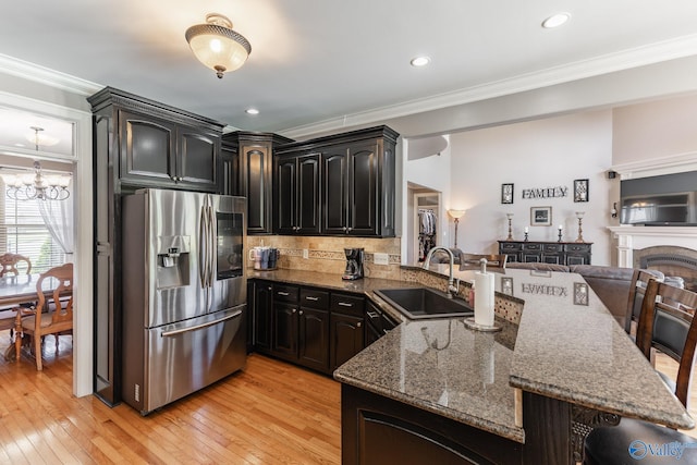 14690 Birchbark St, Athens, AL 35613 - kitchen with crown molding, a sink, stainless steel fridge with ice dispenser, dark stone countertops, and a peninsula