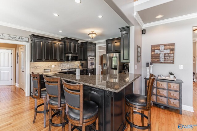 14690 Birchbark St, Athens, AL 35613 - kitchen featuring ornamental molding, a breakfast bar area, stainless steel appliances, and light wood finished floors