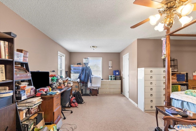 office area with ceiling fan, light colored carpet, and a textured ceiling