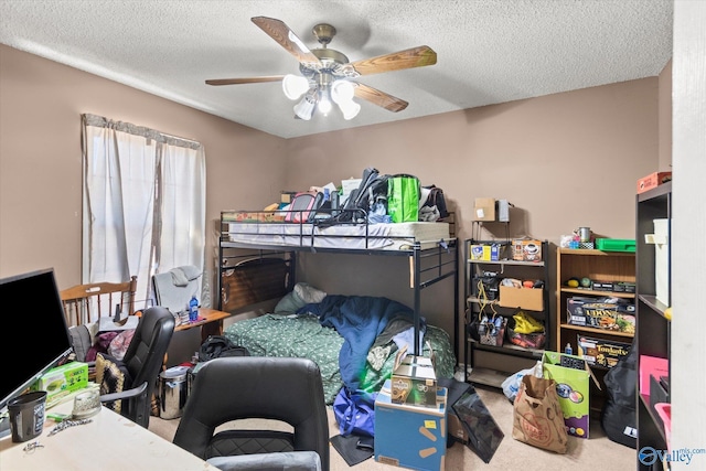 bedroom featuring a textured ceiling, carpet floors, and ceiling fan