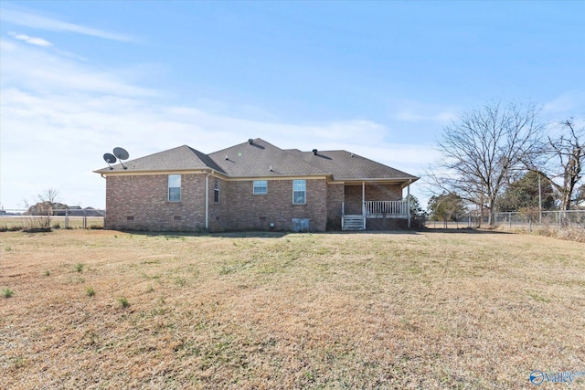 rear view of house with a yard and covered porch