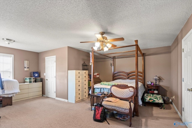 bedroom with light carpet, a textured ceiling, and ceiling fan