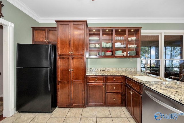 kitchen with dishwasher, black fridge, light tile patterned flooring, crown molding, and light stone countertops