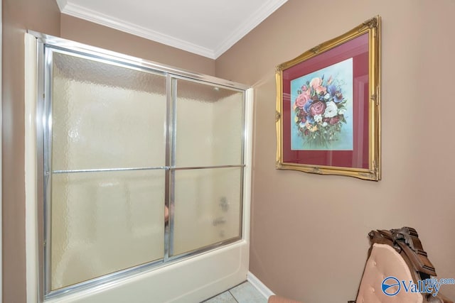 bathroom featuring combined bath / shower with glass door, ornamental molding, and tile patterned floors