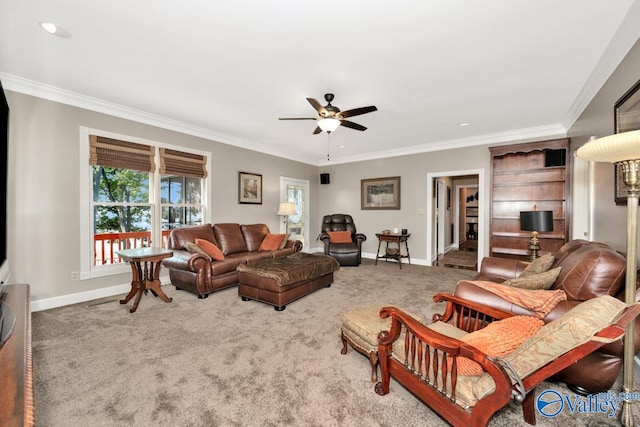 living room with ornamental molding, carpet, and ceiling fan