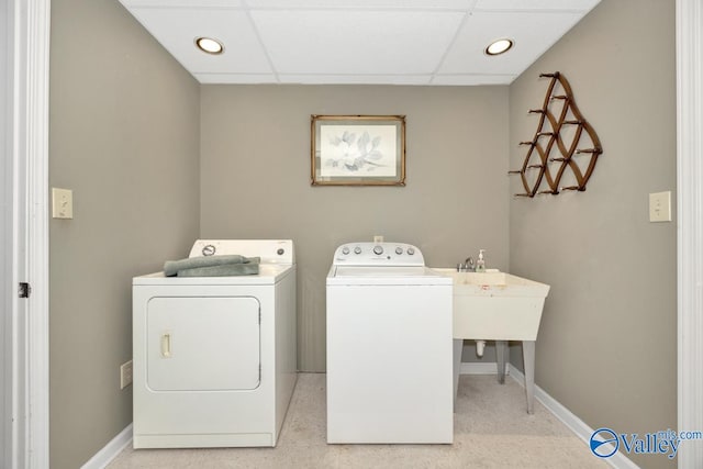 clothes washing area with washing machine and clothes dryer