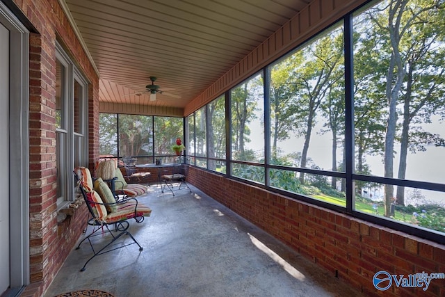 unfurnished sunroom featuring ceiling fan