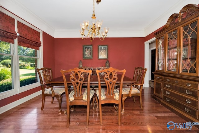 dining area with ornamental molding, a notable chandelier, and dark hardwood / wood-style flooring