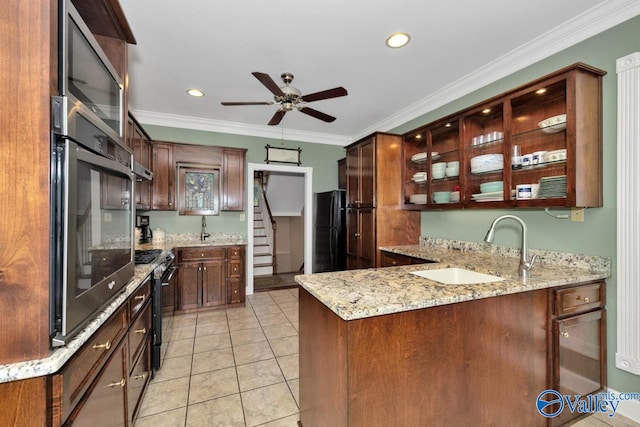 kitchen featuring ornamental molding, kitchen peninsula, appliances with stainless steel finishes, and sink