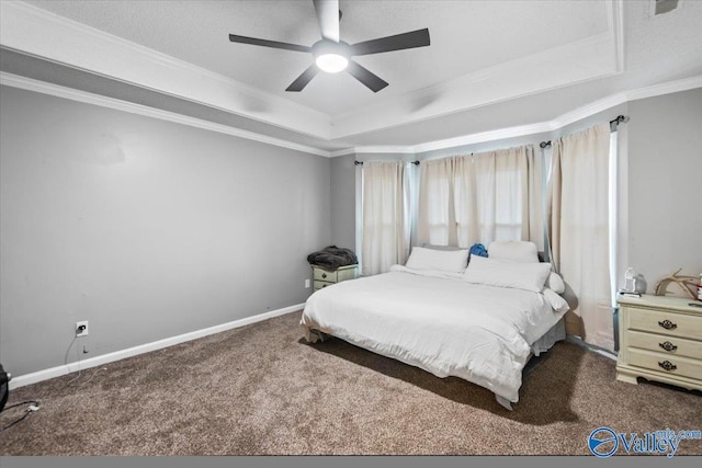 carpeted bedroom featuring a tray ceiling, ceiling fan, and ornamental molding