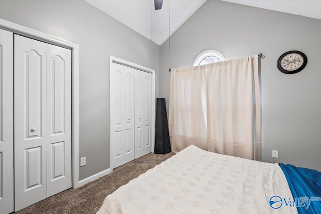 carpeted bedroom featuring ceiling fan, lofted ceiling, and multiple closets