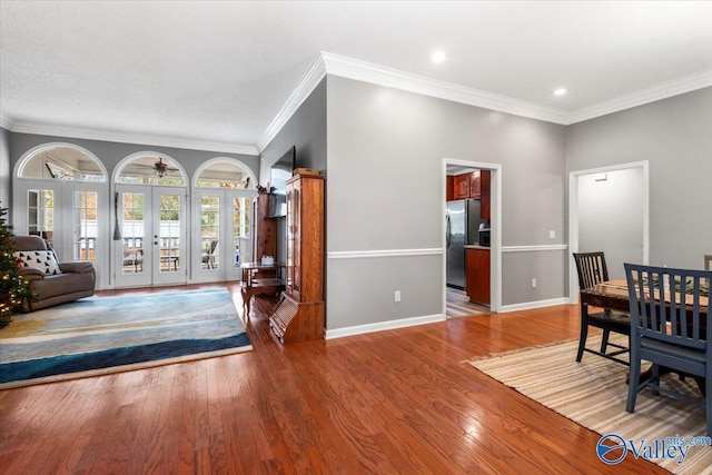 dining area featuring hardwood / wood-style floors, french doors, and ornamental molding