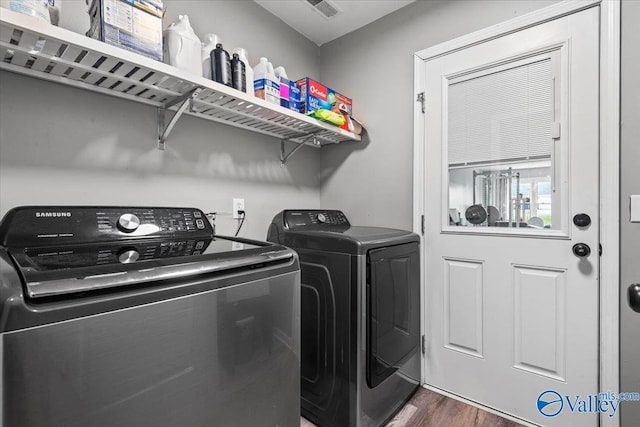 washroom with independent washer and dryer and dark hardwood / wood-style flooring