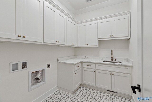 laundry room featuring sink, crown molding, cabinets, washer hookup, and hookup for an electric dryer