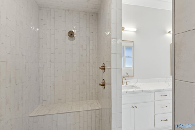 bathroom with vanity and a tile shower