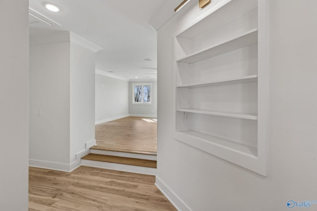 corridor featuring crown molding and light wood-type flooring