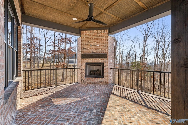 view of patio / terrace featuring an outdoor brick fireplace and ceiling fan