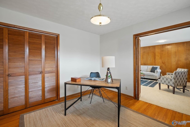 office area with baseboards and wood finished floors