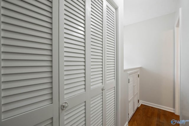 interior space with baseboards and wood finished floors