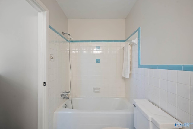 full bathroom featuring toilet, shower / washtub combination, and tile walls