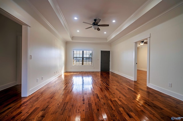 interior space featuring dark wood-type flooring, ceiling fan, ornamental molding, and a raised ceiling