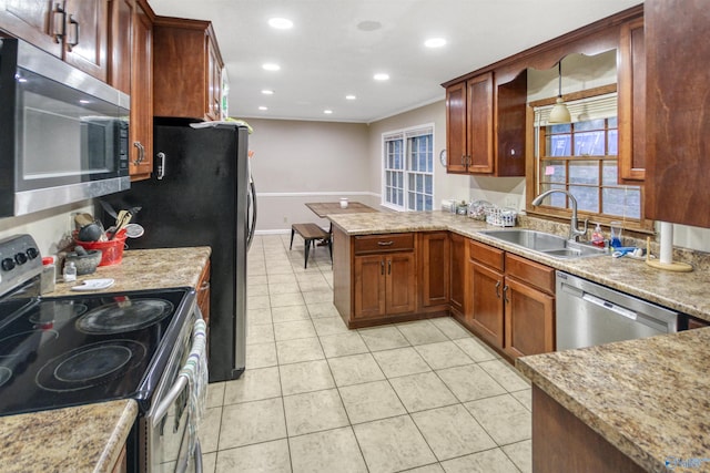 kitchen featuring appliances with stainless steel finishes, light tile patterned flooring, sink, and light stone counters