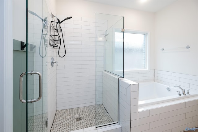 bathroom featuring separate shower and tub