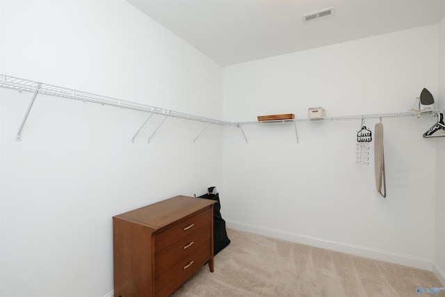 spacious closet featuring light carpet