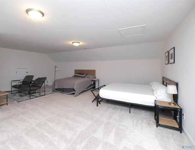 bedroom featuring light colored carpet and lofted ceiling