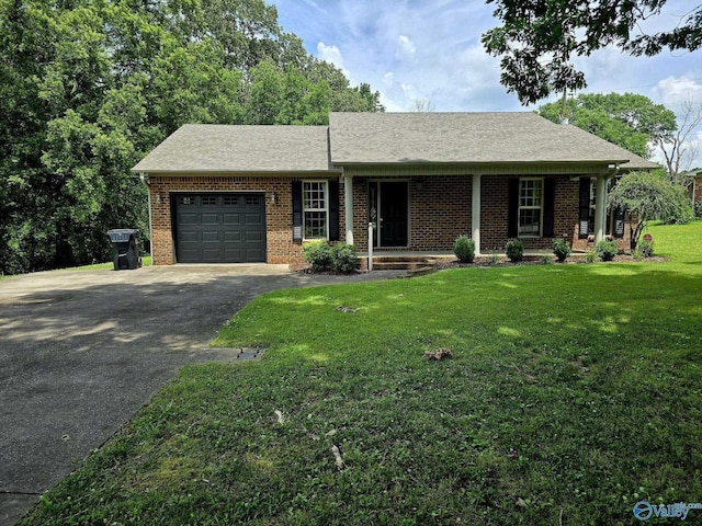 67 Forest Chapel Rd, Hartselle, AL 35640 - single story home featuring asphalt driveway, an attached garage, brick siding, a front lawn, and a shingled roof