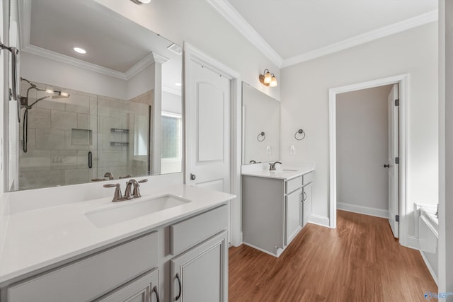 bathroom featuring vanity, independent shower and bath, crown molding, and hardwood / wood-style flooring