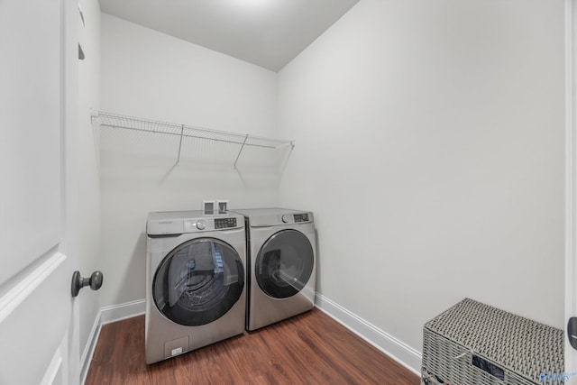 clothes washing area featuring dark hardwood / wood-style floors and separate washer and dryer