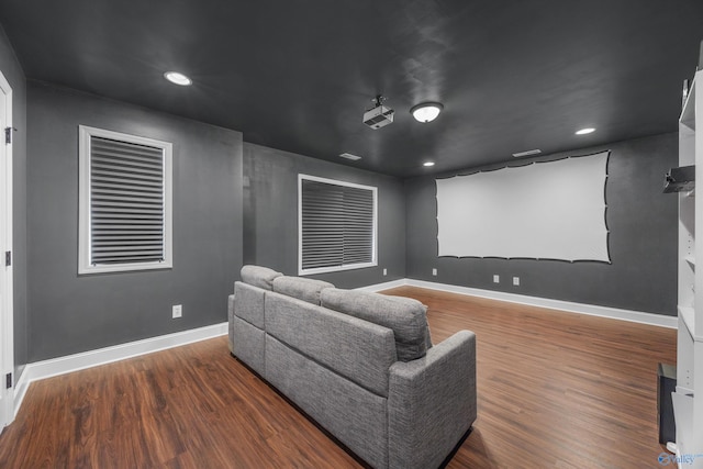 home theater room with dark hardwood / wood-style flooring