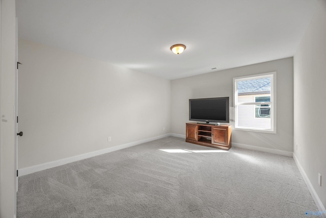 unfurnished living room featuring light carpet