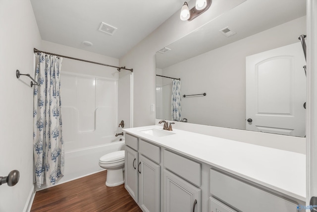 full bathroom featuring toilet, hardwood / wood-style flooring, shower / bath combo with shower curtain, and vanity