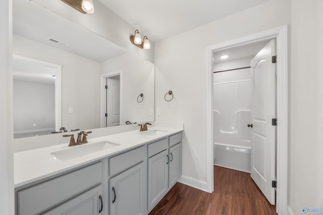 bathroom featuring vanity, a shower, and wood-type flooring