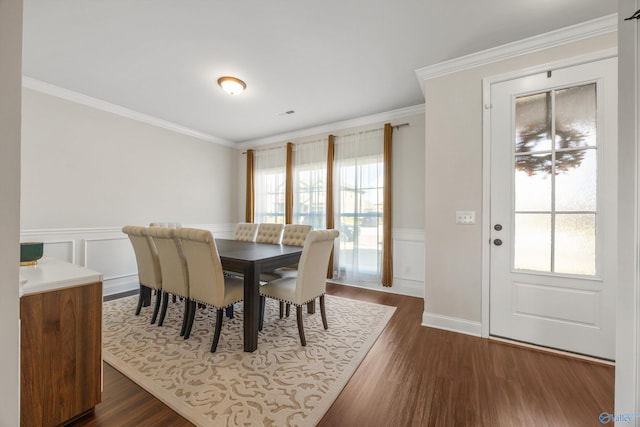 dining room with dark wood-type flooring and ornamental molding