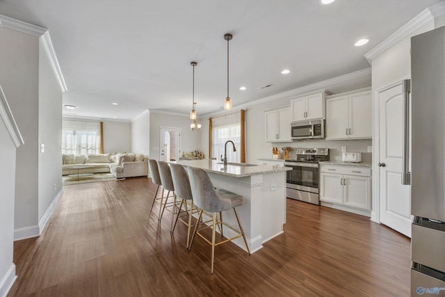 kitchen featuring appliances with stainless steel finishes, white cabinets, plenty of natural light, and dark hardwood / wood-style flooring