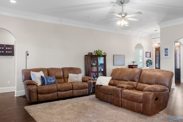 living room featuring ornamental molding, arched walkways, dark wood-style flooring, and baseboards