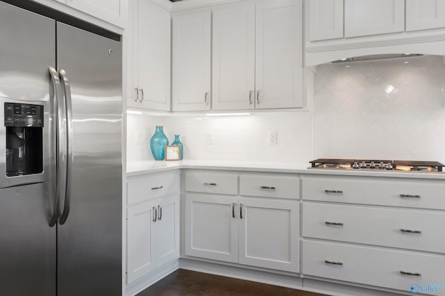 kitchen featuring appliances with stainless steel finishes, white cabinets, light countertops, and tasteful backsplash