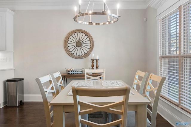 dining area featuring dark wood-style floors, baseboards, ornamental molding, and a chandelier