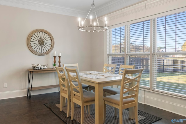 dining room with dark wood-style floors, an inviting chandelier, baseboards, and crown molding