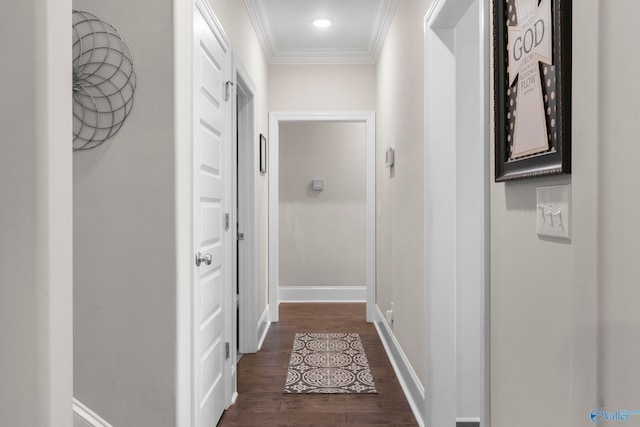 hallway featuring dark wood-style floors, baseboards, and crown molding