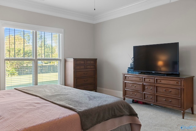 bedroom with ornamental molding, light carpet, and baseboards