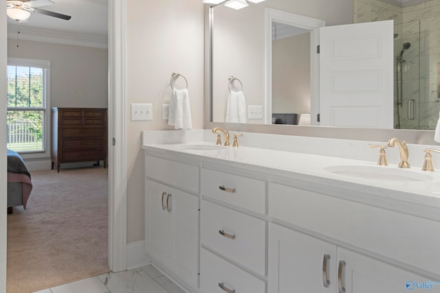 ensuite bathroom featuring ornamental molding, marble finish floor, a sink, and ensuite bath