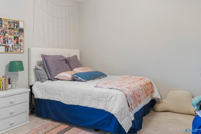 bedroom featuring light carpet