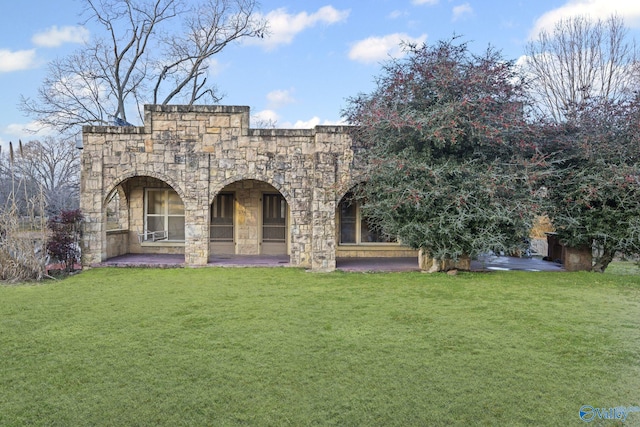 back of house with a lawn and a patio area