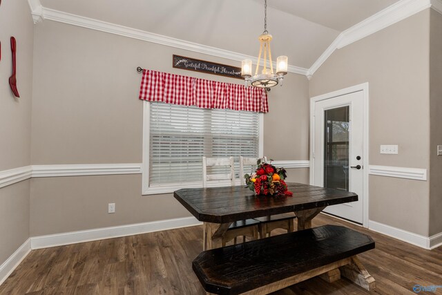 dining room featuring crown molding, dark hardwood / wood-style floors, and vaulted ceiling