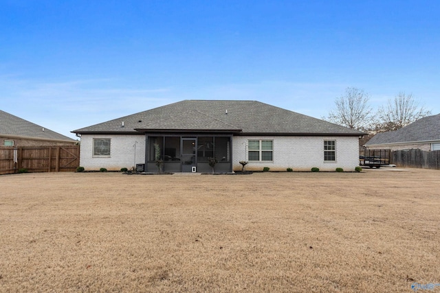 rear view of property with a sunroom